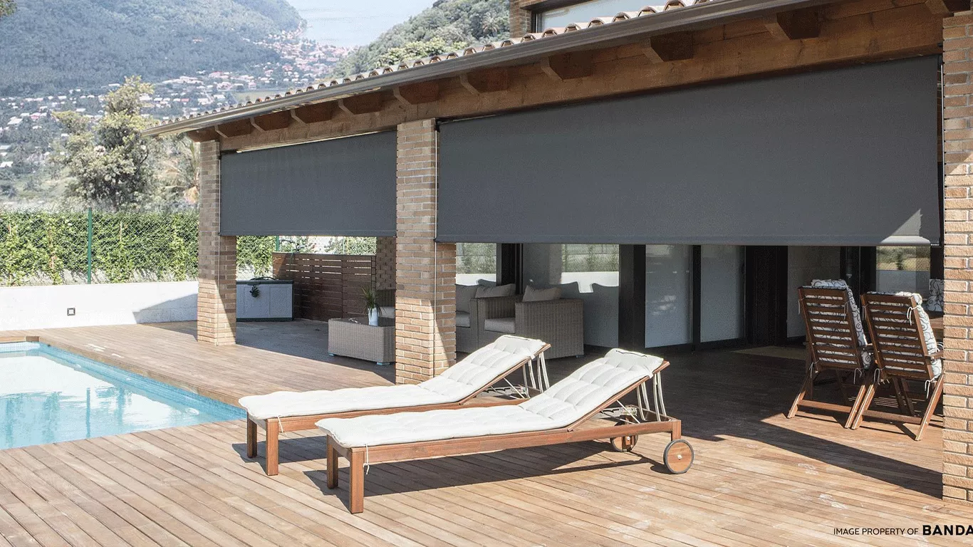 Waterproof patio shades protecting an outdoor living area from sun and rain near a pool in Arizona